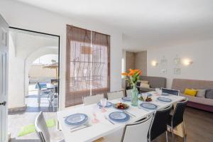a dining room with a white table and chairs at Fidalsa Relax Pool your Refuge in Torrevieja