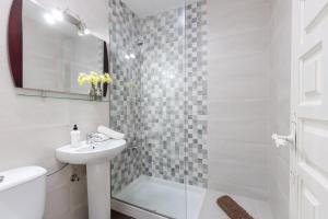 a white bathroom with a sink and a shower at Fidalsa Relax Pool your Refuge in Torrevieja +22 photos