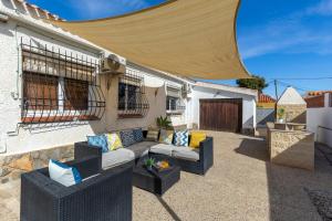 a patio with a couch and chairs in front of a building at Fidalsa Relax Pool your Refuge in Torrevieja