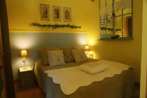 a bedroom with a large bed with a white blanket at Gite Les Trois Collines in Cuisiat