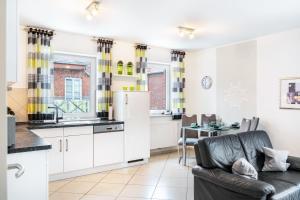 a kitchen and living room with a couch and a table at Ferienwohnung Hilbers in Horumersiel