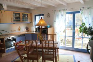 a kitchen with a table and chairs and a dining room at Märchengarten Fischer un sin Fru in Putbus
