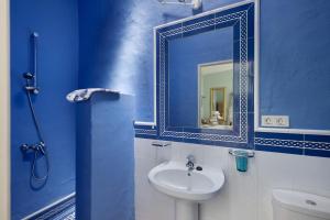 a blue bathroom with a sink and a mirror at El Piccolo in Mácher +12 photos