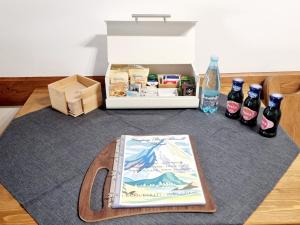 a book sitting on a table with bottles of beer at Appartamento Adamello 5 in Pinzolo +8 photos