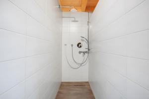 a bathroom with a shower in a white wall at Hochtalblick - Fewo Oren in Bernau im Schwarzwald +21 photos