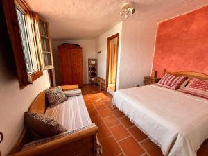 a bedroom with a bed and a bench in a room at Casa Reija in Son Parc