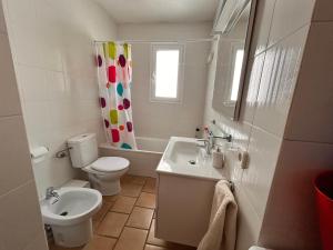 a white bathroom with a toilet and a sink at Casa Reija in Son Parc +17 photos