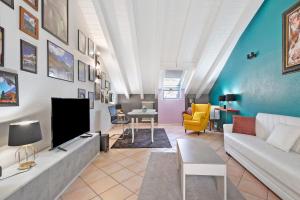 a living room with a couch and a tv at Mema Holiday Home in Aosta