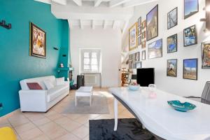 a living room with a white table and a couch at Mema Holiday Home in Aosta +24 photos