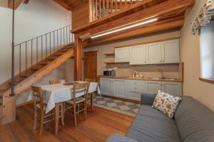 a kitchen and dining room with a couch and a table at Civico 13 in Marmora