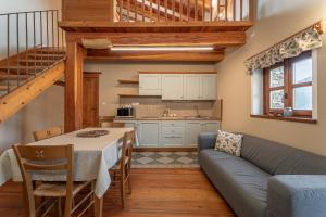 a kitchen and living room with a couch and a table at Civico 13 in Marmora