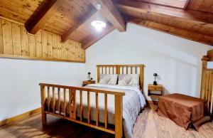 a bedroom with a bed and a wooden ceiling at Appartamento Adamello 9 in Pinzolo