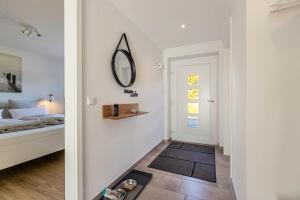a bedroom with a bed and a mirror on the wall at Ferienhaus Waterkant mit Hund in Klanxbüll