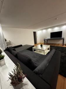 a living room with a couch and a table at Rosenhaus in Merchweiler