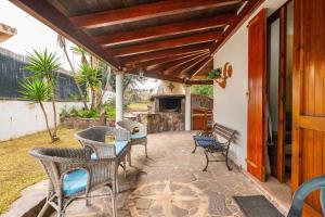 a patio with wicker chairs and a fireplace at Brezza di Mare in Calasetta