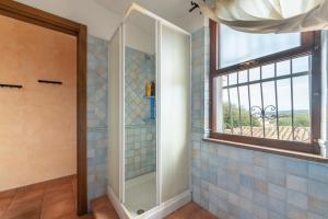 a bathroom with a shower and a window at Brezza di Mare in Calasetta +17 photos
