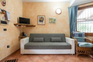 a living room with a couch and a chair at Brezza di Mare in Calasetta