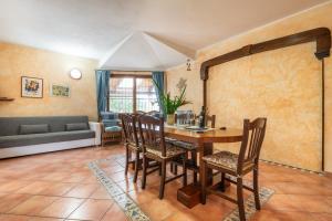 a living room with a wooden table and chairs at Brezza di Mare in Calasetta