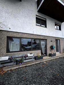 a building with windows and plants on the side of it at Rosenhaus in Merchweiler