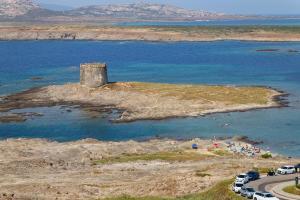 an island with a tower in the middle of the water at Villa Grecale in Stintino