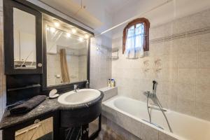 a bathroom with a sink and a bath tub at House Theodora holidays Greece in Dragotiná +26 photos