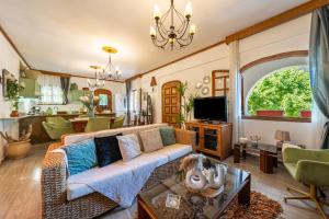 a living room with a couch and a table at House Theodora holidays Greece in Dragotiná