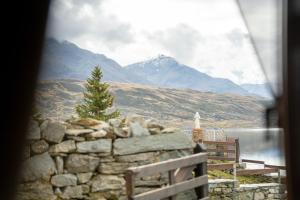 a stone wall with a view of a mountain at Agriturismo Montespluga in Madesimo