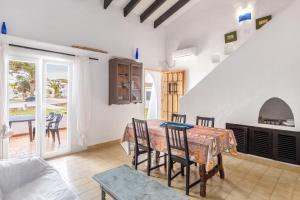a kitchen and dining room with a table and chairs at Cala Serena Beach 5 in Felanitx