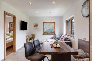 a living room with a table and a couch at Apart Elias in Gschnallenhof