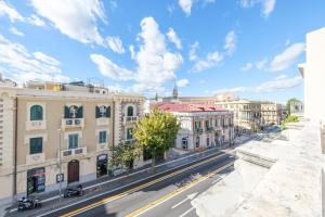 a view of a city street with buildings at Epoque in Messina