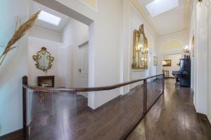 a hallway with a staircase and a mirror on the wall at Epoque in Messina