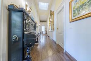 a hallway with a black cabinet in a house at Epoque in Messina