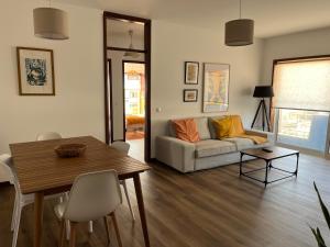 a living room with a couch and a table at Onda Beach House in Cortegaça