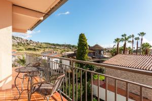 a balcony with a table and chairs and a view at Durero in Pineda de Mar