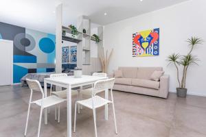 a living room with a white table and chairs at Taormina Center Suite in Taormina +14 photos