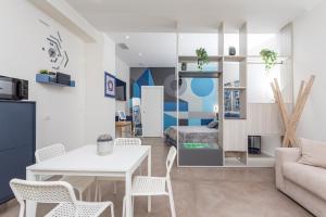 a living room with a white table and chairs at Taormina Center Suite in Taormina