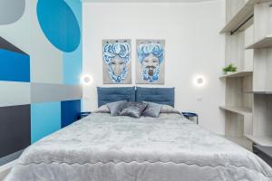 a bedroom with a large bed with blue and white walls at Taormina Center Suite in Taormina