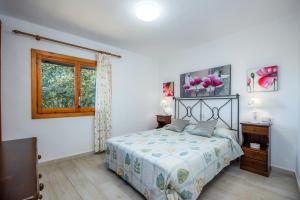 a bedroom with a bed and a window at S' Alzina in Sencelles +26 photos