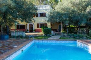 a swimming pool in front of a house at S' Alzina in Sencelles