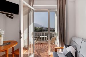 a living room with a sliding glass door leading to a balcony at Apartamentos Martin - 22 in Puerto Naos