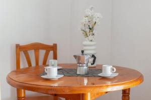 a table with a coffee pot and cups on it at Apartamentos Martin - 22 in Puerto Naos