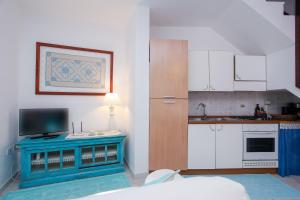 a kitchen with a blue table in a room at mirtagru casa della Sughereta in Budoni