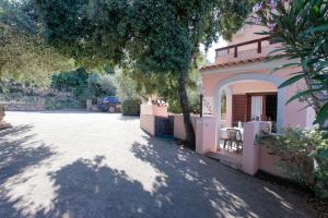 a house with a driveway in front of it at mirtagru casa della Sughereta in Budoni