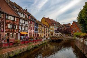 a group of buildings next to a river in a town at Tiny House am Kaiserstuhl in Ihringen