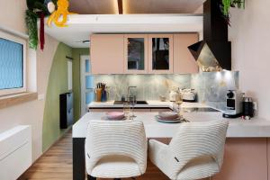 a kitchen with a table and two chairs at Tiny House am Kaiserstuhl in Ihringen