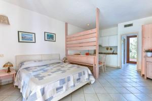 a bedroom with a bunk bed and a desk at Appartamenti Dolores in Campo nell'Elba