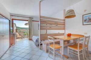 a kitchen and dining room with a table and chairs at Appartamenti Dolores in Campo nell'Elba