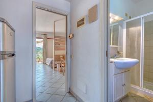 a bathroom with a sink and a mirror at Appartamenti Dolores in Campo nell'Elba +46 photos