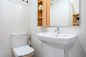 a white bathroom with a sink and a toilet at Loft Sant Joan in L'Ametlla de Mar +11 photos