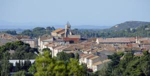 a view of a town with a clock tower at Maison à Sigean in Sigean